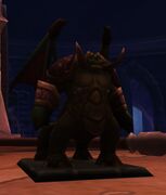 A pit lord figurine used by the Rooksguard in the Chamber of War in Black Rook Hold.